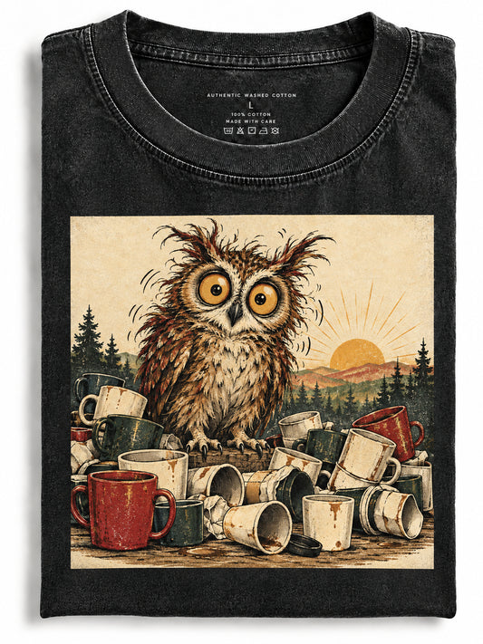 Folded black cotton t-shirt with a caffeinated owl and coffee mugs print