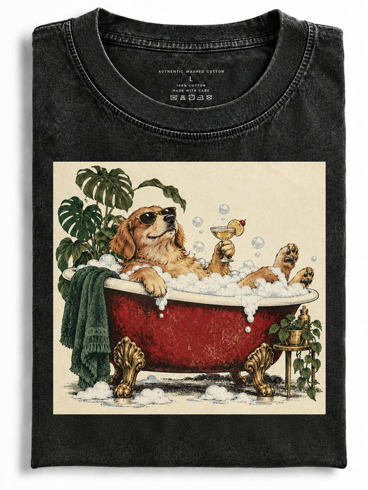 Folded black t-shirt featuring a golden retriever wearing sunglasses relaxing in a red clawfoot bubble bath